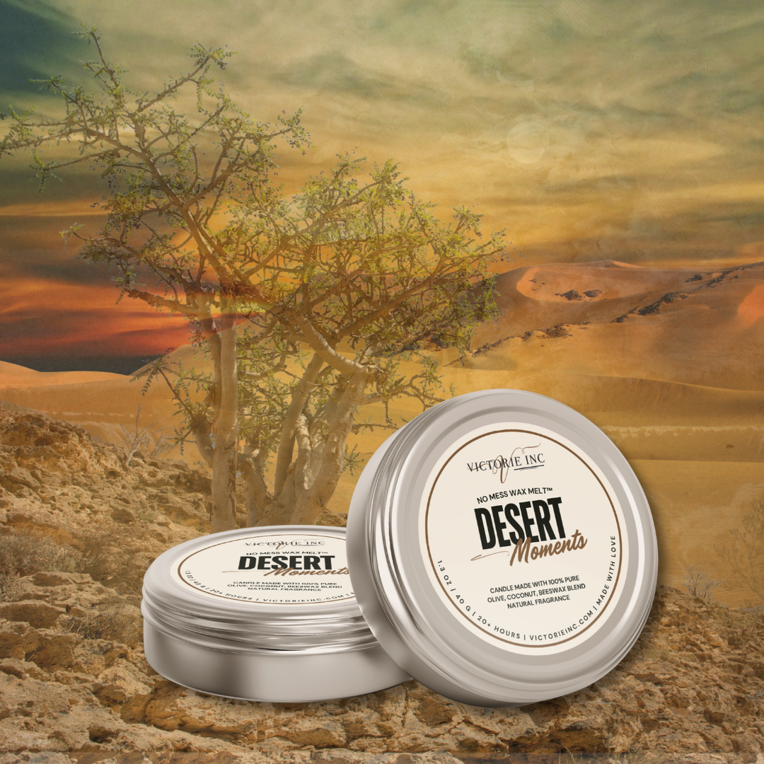 Two tins labeled 'Desert Moments' on a desert landscape with a tree and sunset.