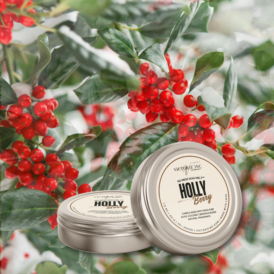 Two containers of 'Holly Berry' scented product surrounded by holly leaves and berries.