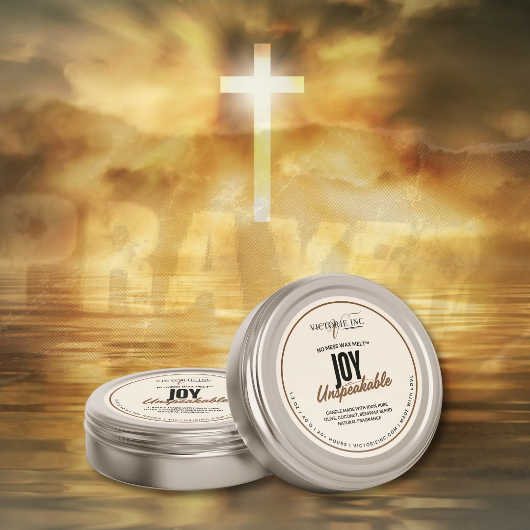Two containers of 'Joy Unspeakable' candle with a cross and blurred background